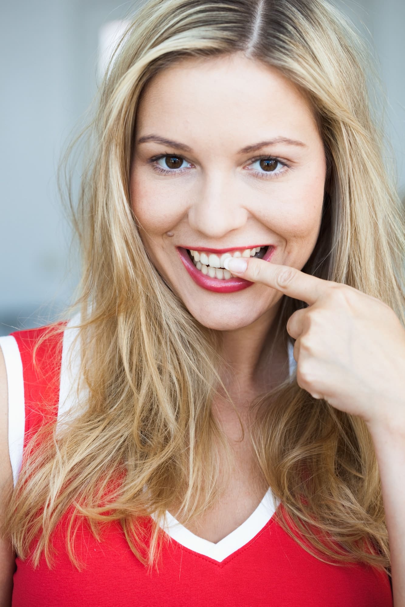 Young woman pointing at her teeth